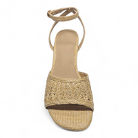 Woven sandal with a brown sole on a white background