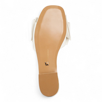 Close-up of a sandal sole with a brand logo on a white background