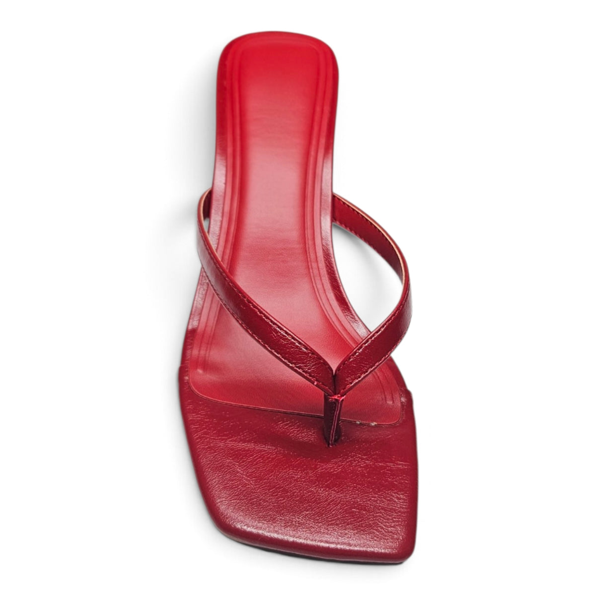 Red patent thong mule sandal showing footbed and T-strap detail, kitten heel