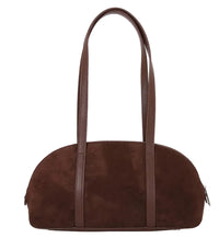 Brown suede handbag with brown handles on a light gray background