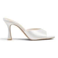 White satin heeled mule with open back, pointed toe, and tall block heel.