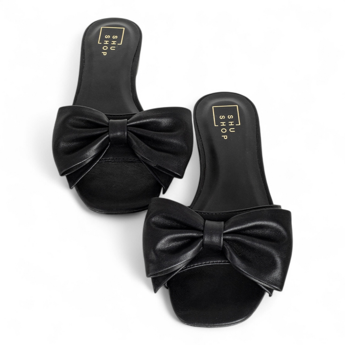 Black sandals with large bows on a white background