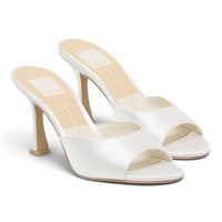 White satin heeled mule with open toe, open back, and tall block heel.