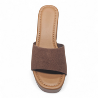 Brown sandal with a thick sole on a white background