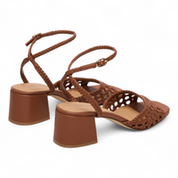 Brown woven sandal with block heel on a white background