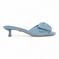 Blue denim sandal with a bow on a white background