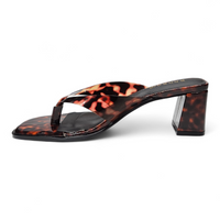 Tortoiseshell high-heeled sandal on a white background