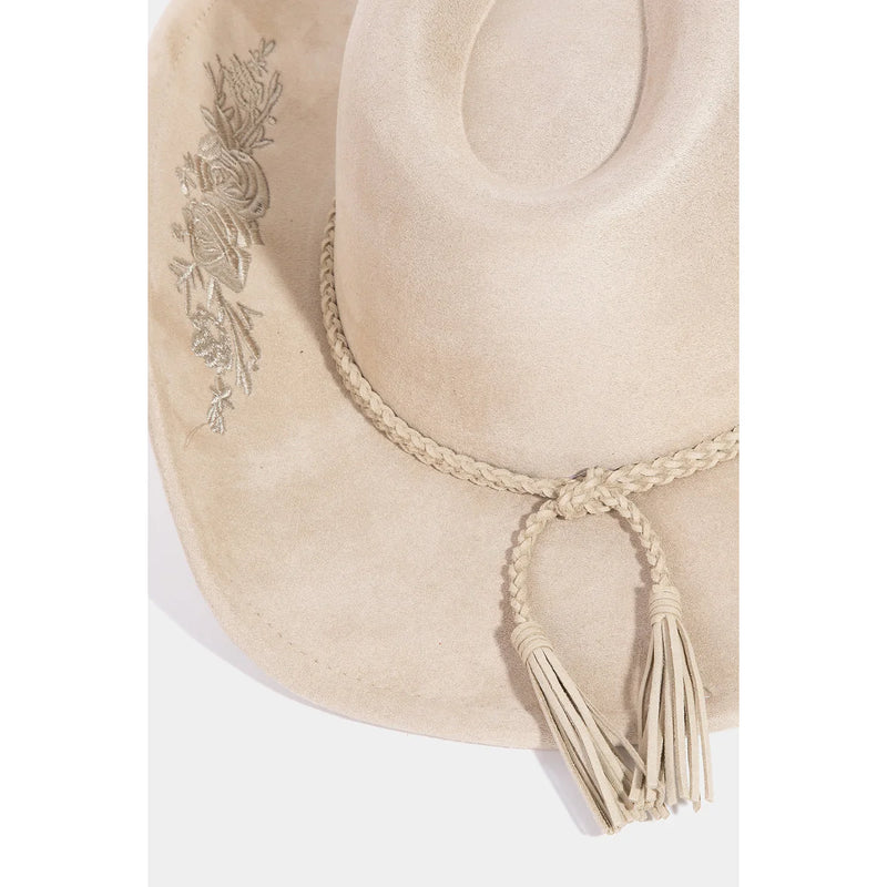 Cream-colored cowboy hat with rose embroidered braided band and tassels