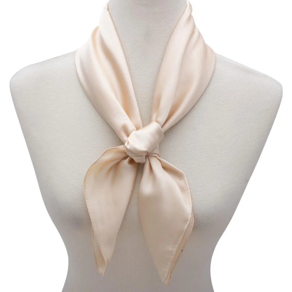 Cream-colored satin solid neck scarf tied in a knot on mannequin’s neck