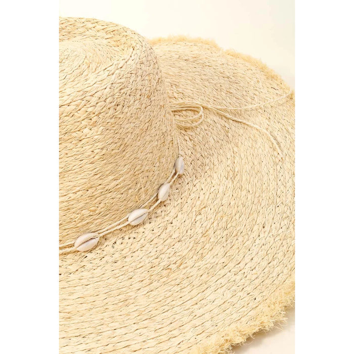 Woven straw sun hat featuring a braid cowrie band adorned with seashells