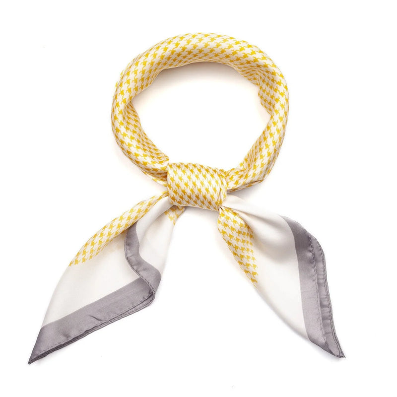 Square silk neck scarf in a yellow and white checkered pattern tied in a knot