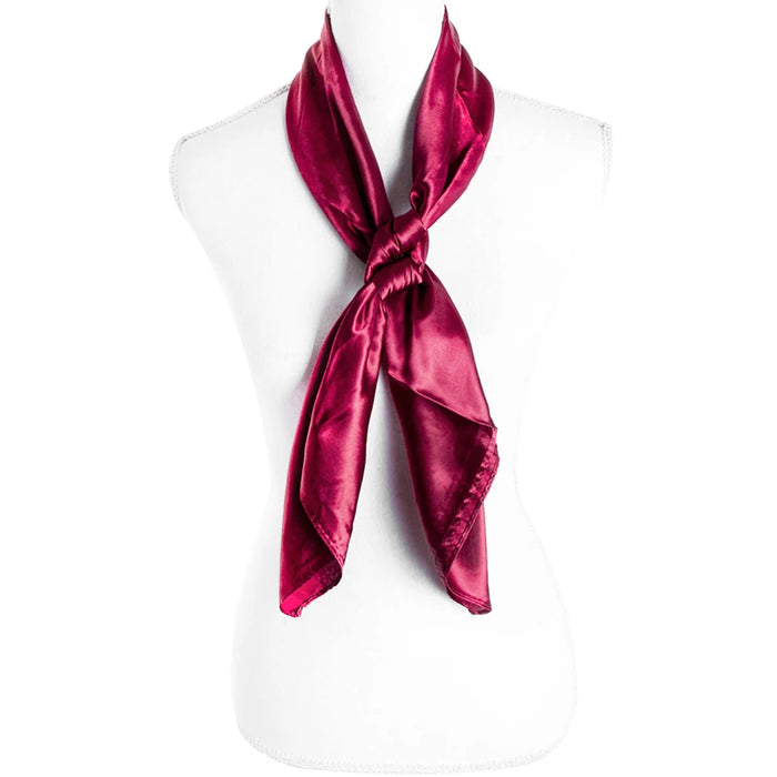 Vibrant magenta silky plain color scarf elegantly tied around a mannequin’s neck