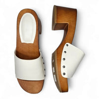 Pair of white leather open toe clogs with wooden soles and studded details