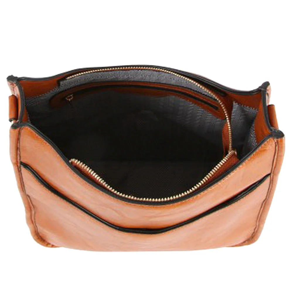 Tan leather crossbody bag with open zipper and dark interior, featuring a guitar strap