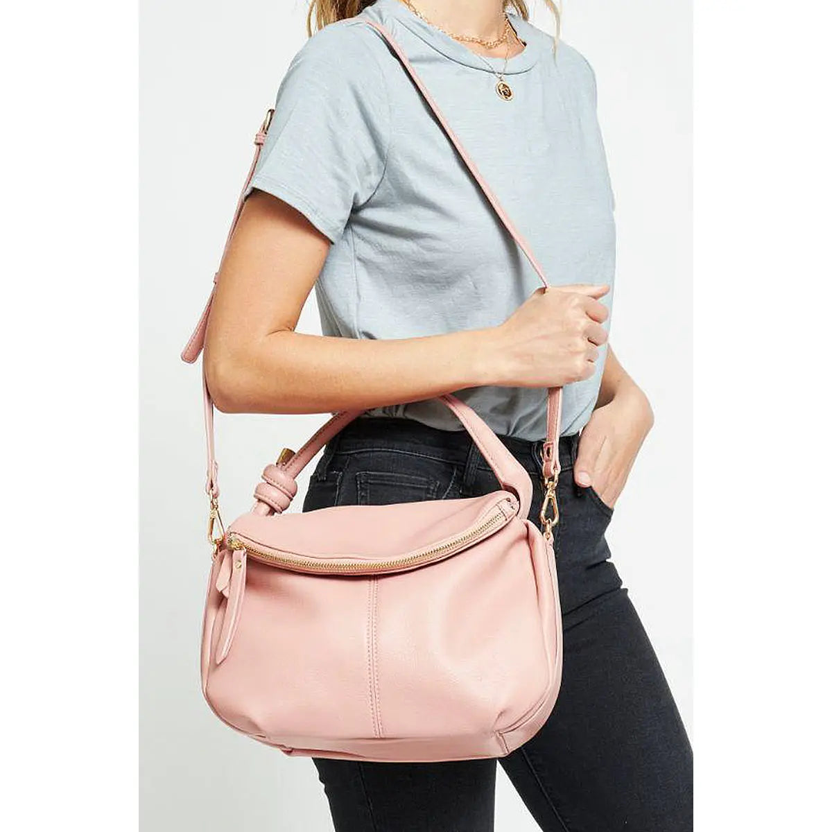 Pink leather messenger bag with shoulder strap and zipper closure for stylish carrying