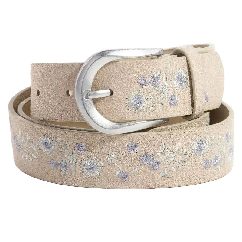 Beige belt with floral embroidery and silver buckle on a white background