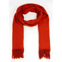 Bright red solid color oblong scarf with fringed ends for stylish winter wear