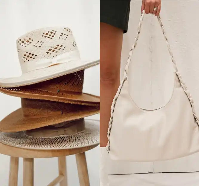 Stack of wide-brimmed straw and woven summer hats alongside a white leather hobo bag.