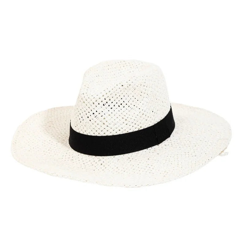 White straw sun hat featuring a stylish black ribbon strap around the crown