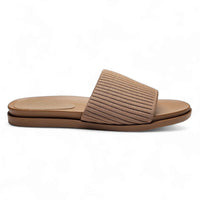 Beige slip-on sandal with stretch woven upper and flat sole for comfort and style