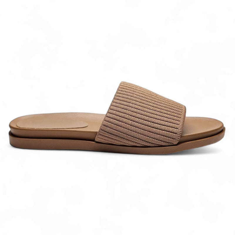 Beige slip-on sandal with stretch woven upper and flat sole for comfort and style