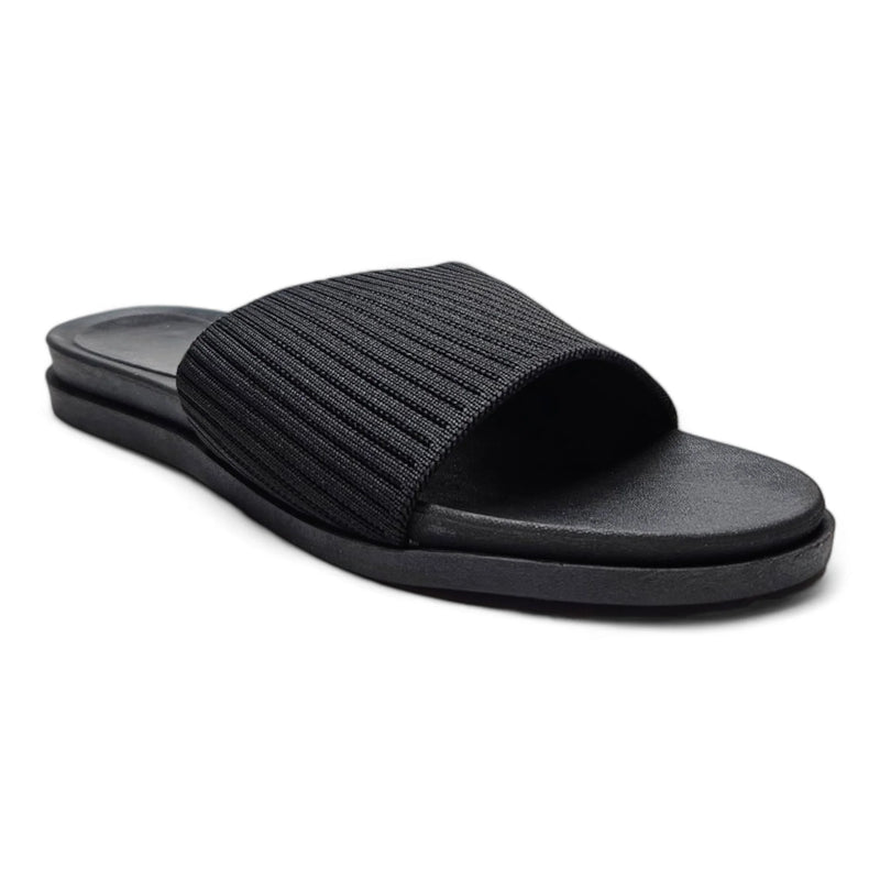 Black slide sandal featuring a stretch woven upper and ribbed fabric strap