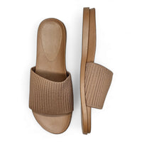 Beige slip-on sandals featuring a stretch woven upper with ribbed fabric straps