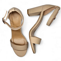 Beige high-heeled sandals with ankle straps for a classic chunky style