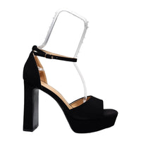 Black high-heeled platform sandal with ankle strap, perfect for When in Vegas Pumps