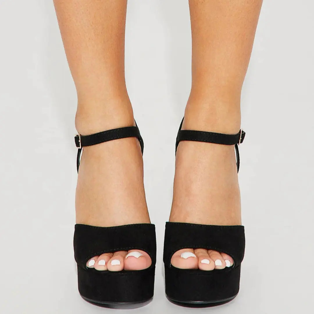 Black platform sandals with ankle straps and open toes from When in Vegas Pumps