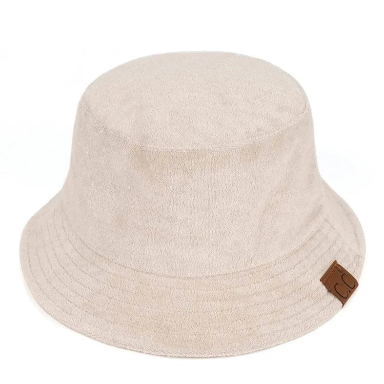 Beige Terry Cloth Bucket Hat featuring a small brown leather tag for style