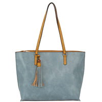 Light blue leather tote bag with tan handles and tassel accent for stylish versatility