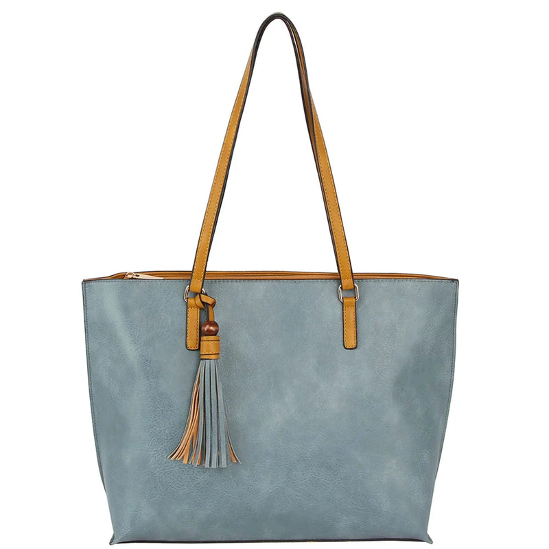 Light blue leather tote bag with tan handles and tassel accent for stylish versatility