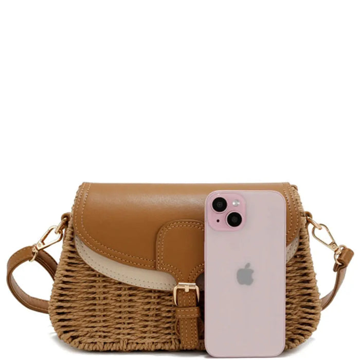 Woven crossbody bag with leather accents featuring a two tone straw design