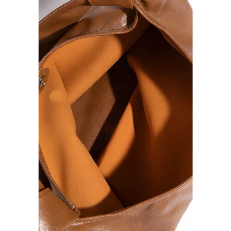 Brown leather tote bag with tan interior lining in weathered faux leather design