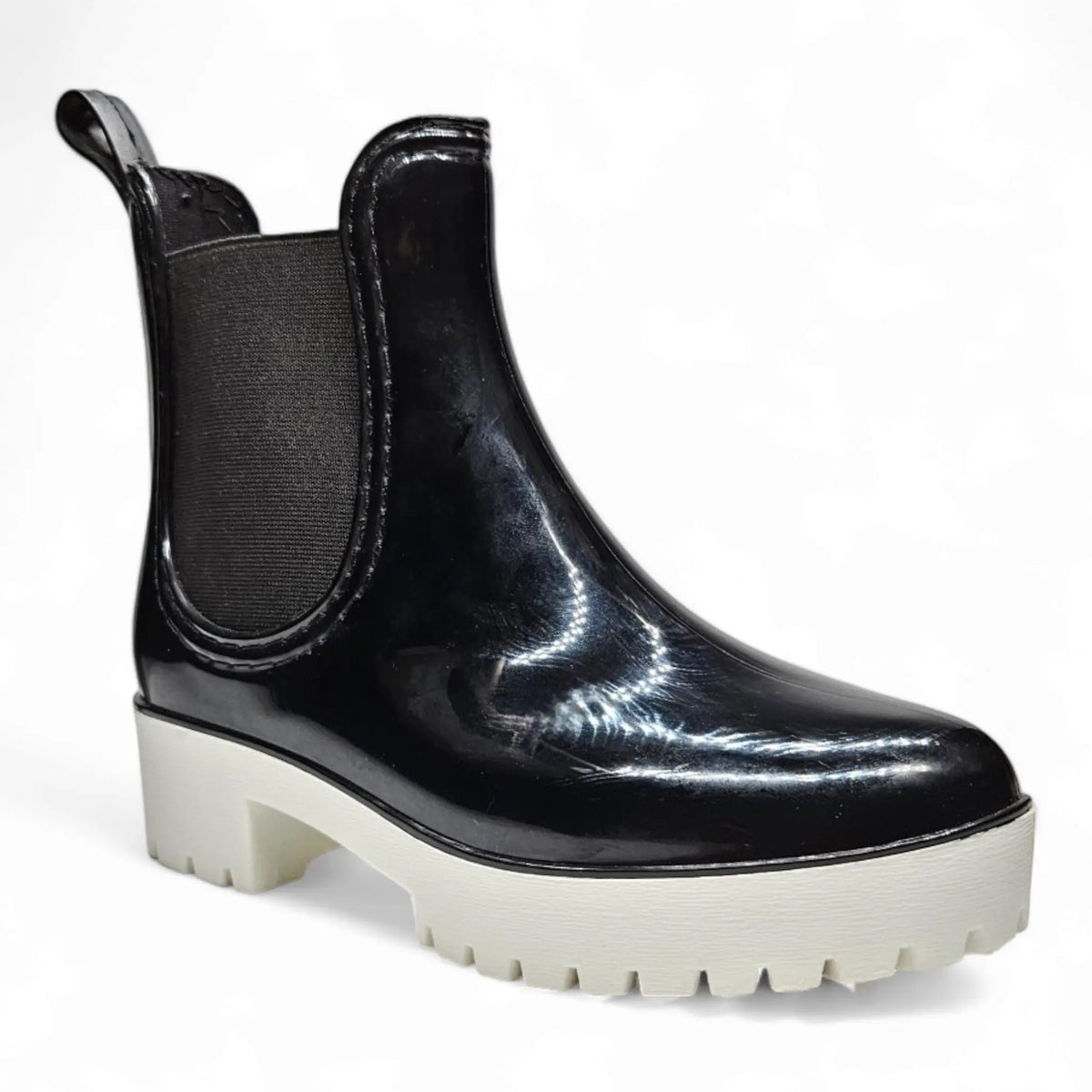 Black patent leather Chelsea boot with chunky white platform sole as a stylish rain bootie