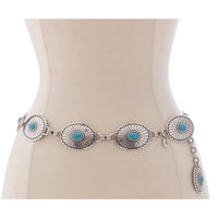 Silver concho belt with turquoise stones on a mannequin, showcasing western style metal