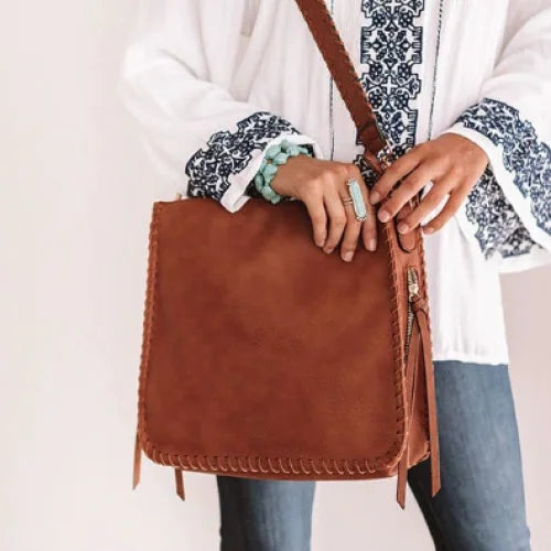 Brown leather whipstitch crossbody bag with decorative edge stitching