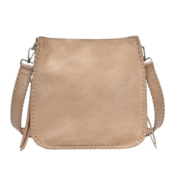 Beige leather whipstitch crossbody bag with adjustable strap and trim detail